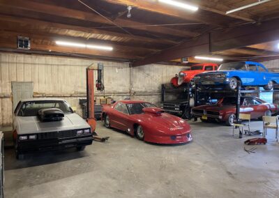 A garage filled with various cars parked inside.
