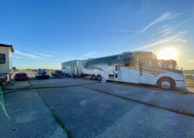 White and black RV parked on paved