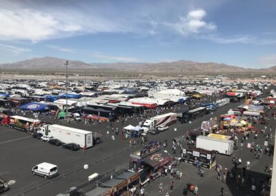 A busy parking lot filled with numerous trucks and cars.