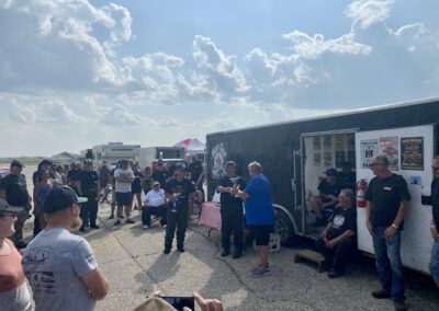 A diverse crowd gathers around a food truck, eagerly waiting to savor delicious meals and enjoy the lively atmosphere.